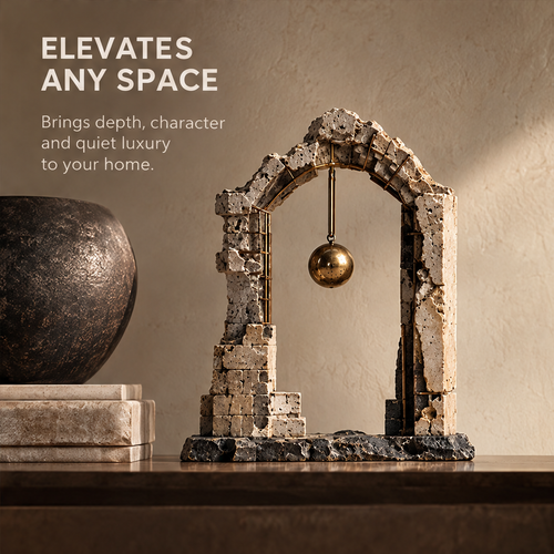 Full view of ruin-inspired arch sculpture with hanging gold-tone orb, without text